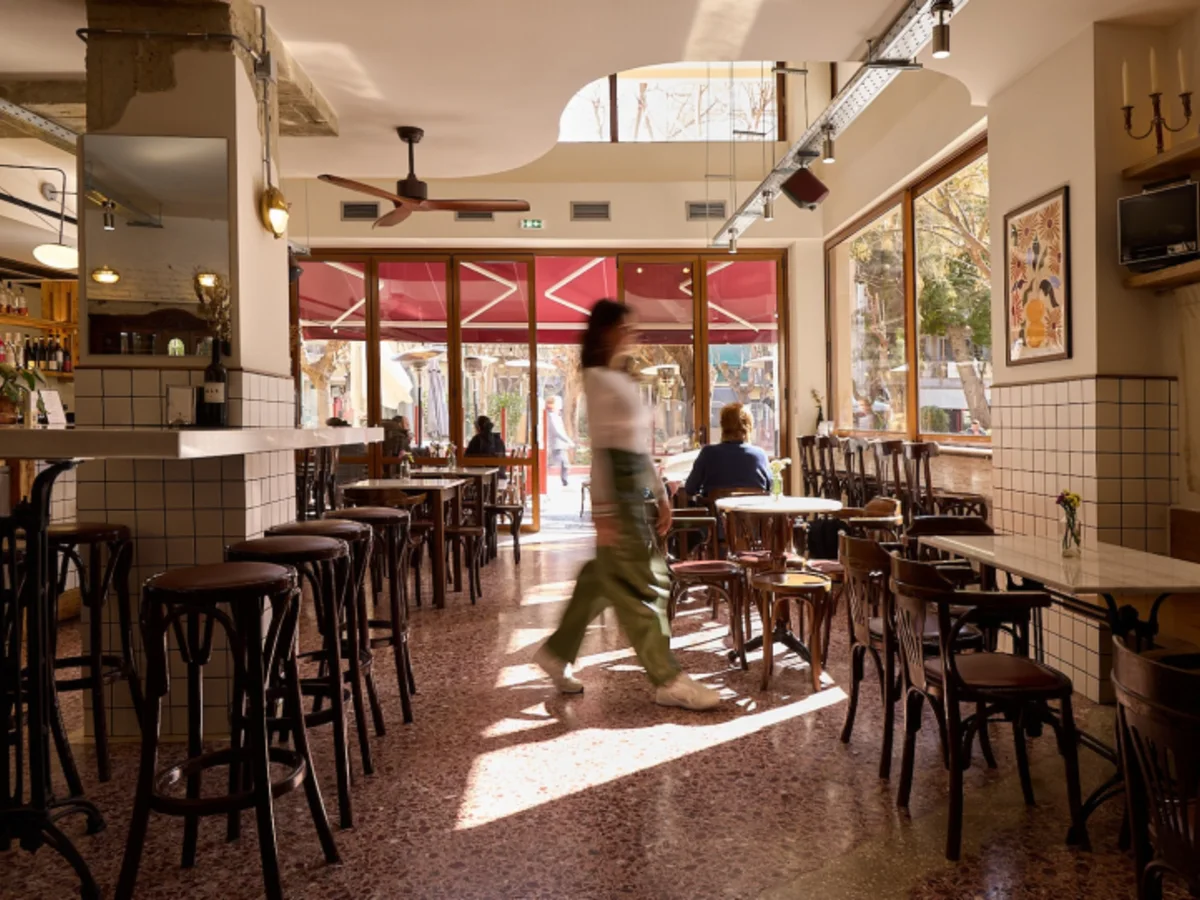 Sunlit dining room and bar inside Topa restaurant in Kypseli
